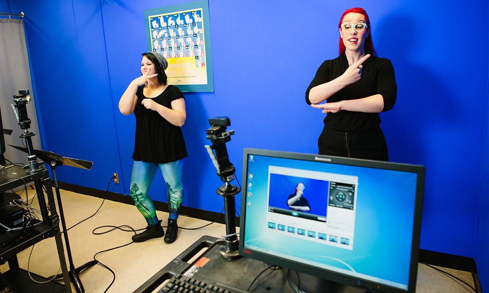ASL sign language interpreter signing for a video shoot